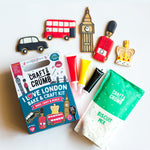 London-themed bake kit with cookies shaped like a bus, taxi, Big Ben, and a guard, plus icing tubes and biscuit mix.
