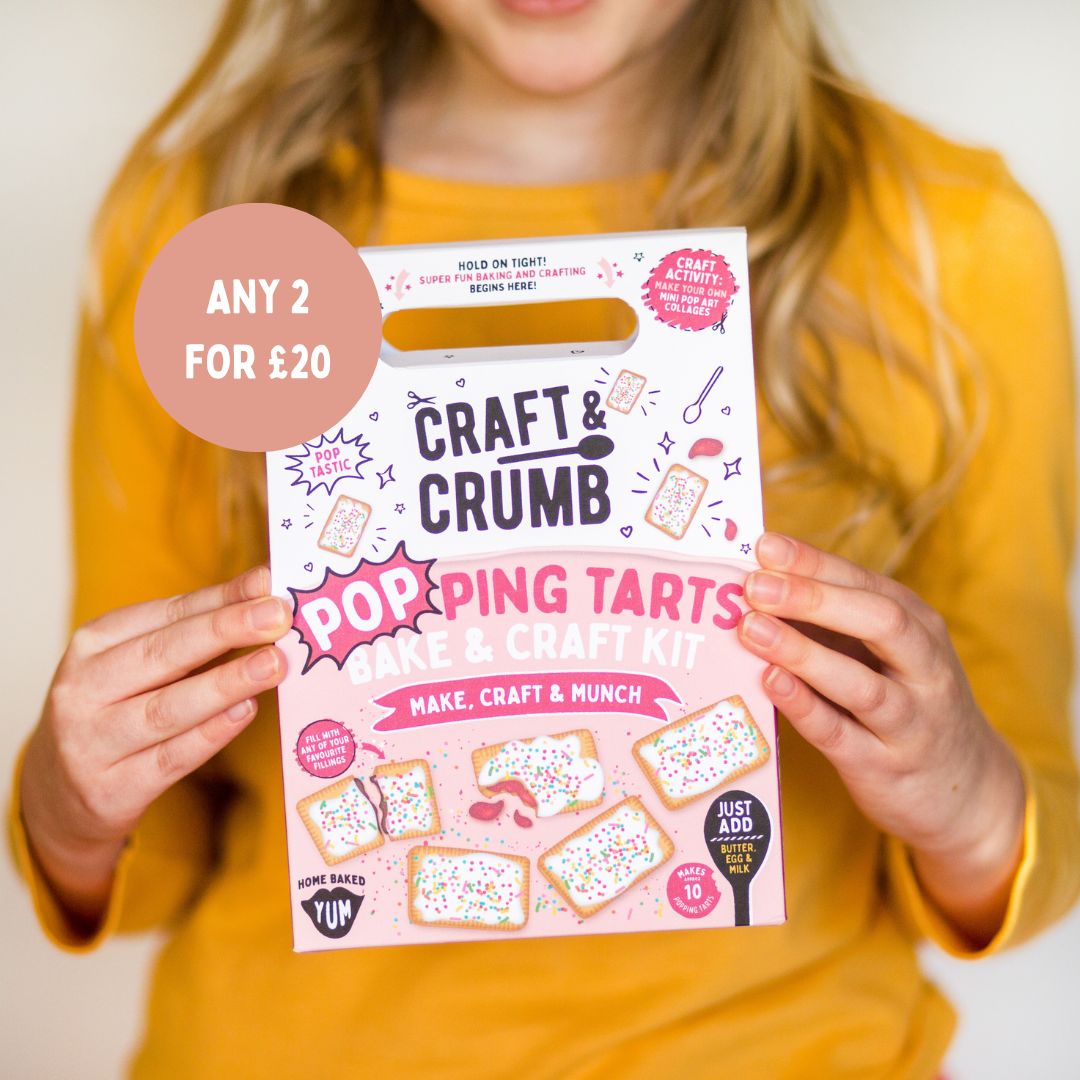 Child holding a "Craft & Crumb" Pop Tarts bake and craft kit, wearing a yellow shirt.
