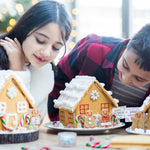 Two children decorating gingerbread houses with candy, smiling and focused, with a festive background.