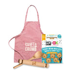 Teddy bear biscuit kit with apron and rolling pins, featuring Craft & Crumb branding.