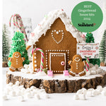 Gingerbread house with candy decorations, gingerbread figures, and a sign reading "Cassy's Gingerbread Cottage."