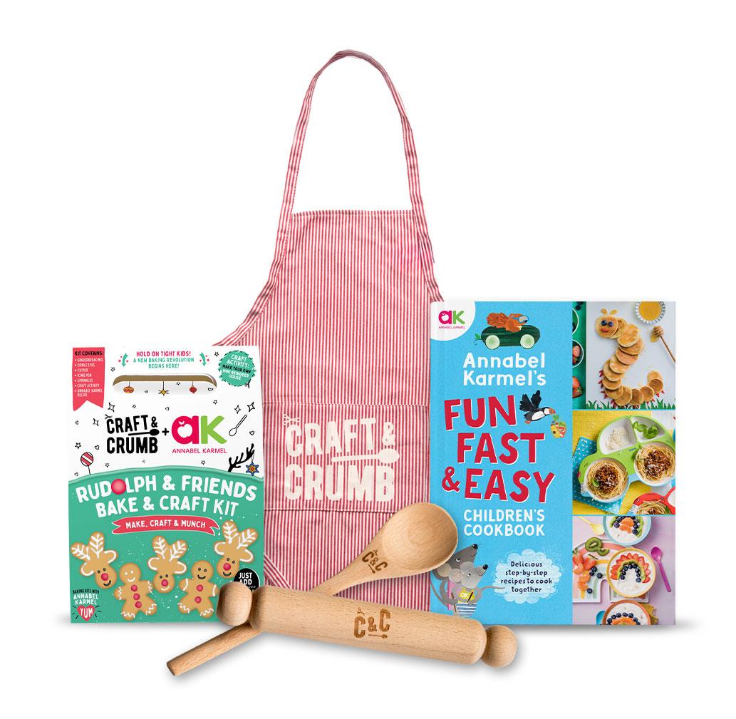 Children's cooking set with apron, cookbook, baking kit, and wooden utensils.
